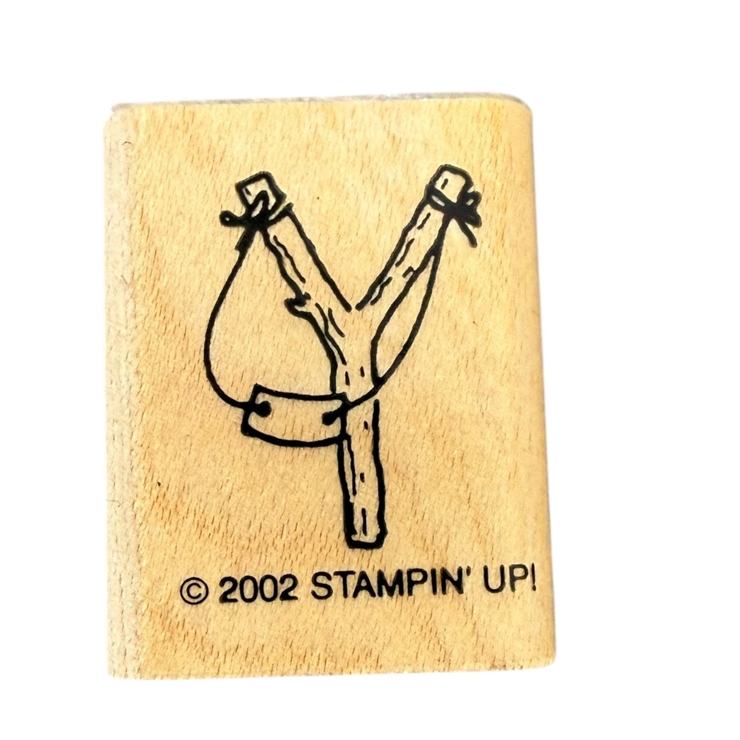 Wooden stamp with a sling shot and 'Stampin' Up!' branding on a white background