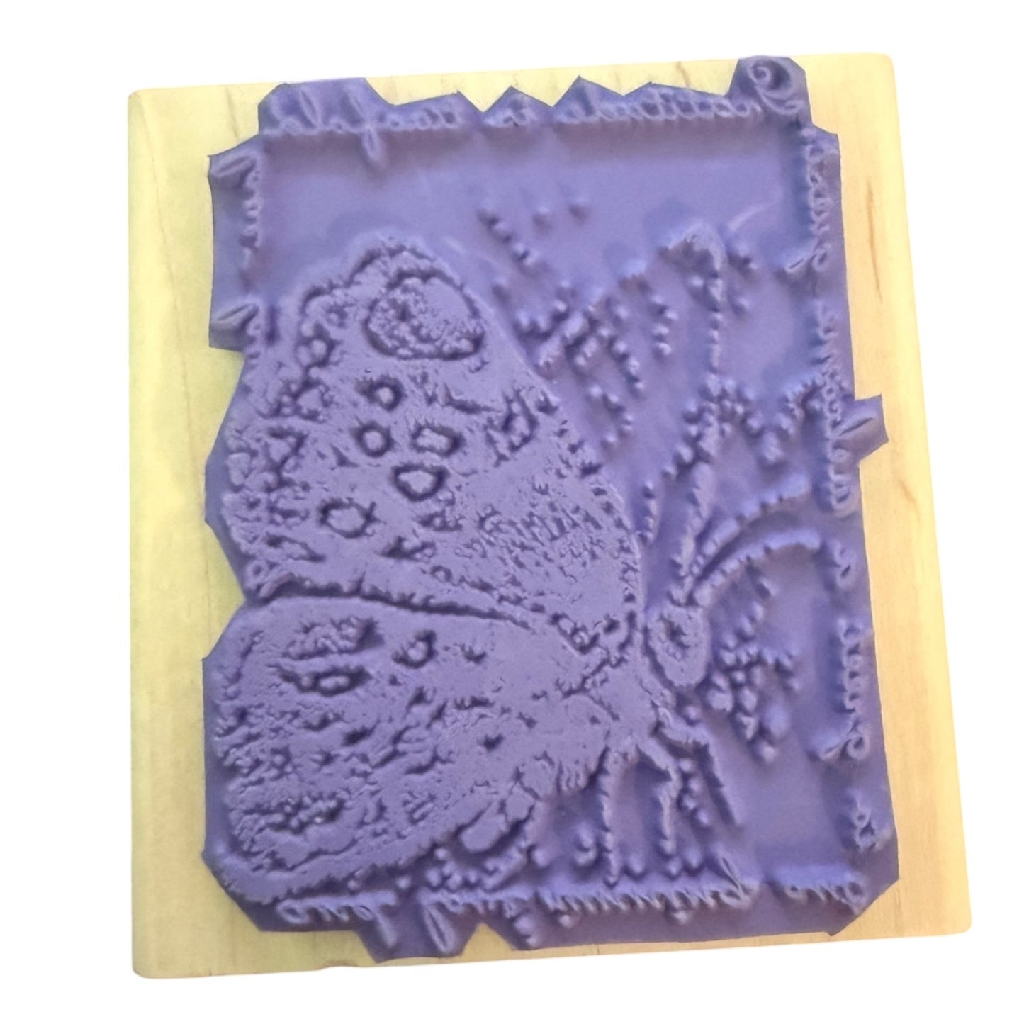 Purple butterfly stamp on a wood block
