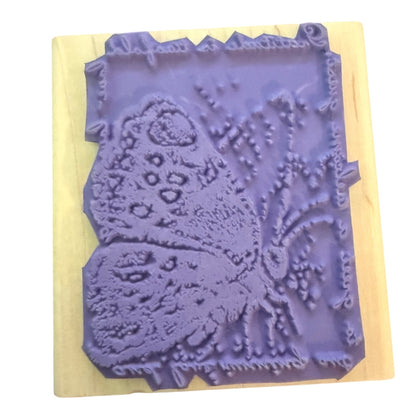 Purple butterfly stamp on a wood block