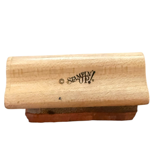 A wooden stamp block with a natural light wood top and a brown wooden base, featuring the 'Stampy Up!' logo printed on the side, set against a plain white background.