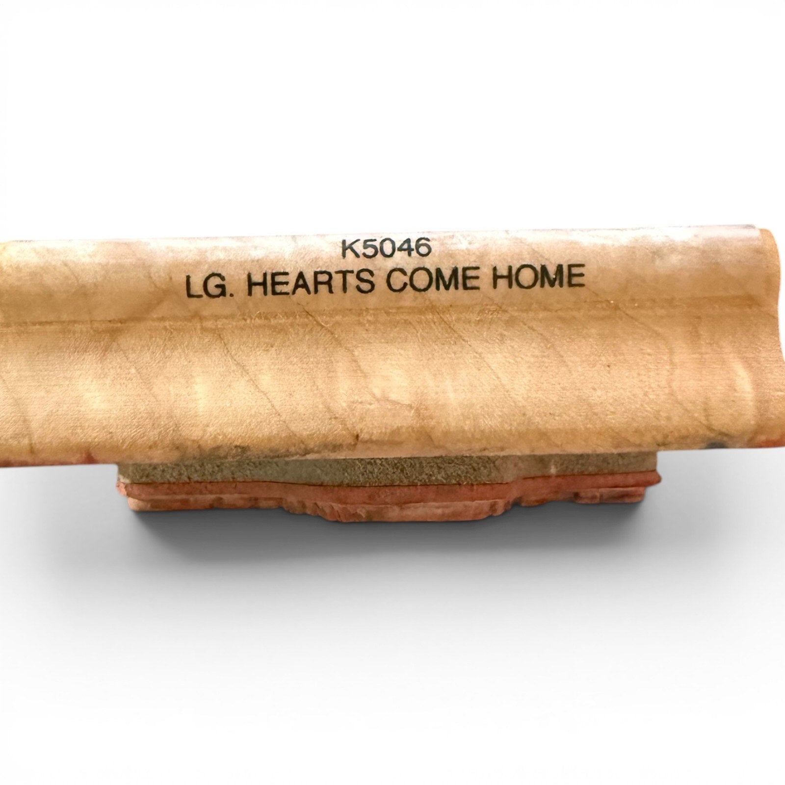 Wooden block with engraved text on a white background