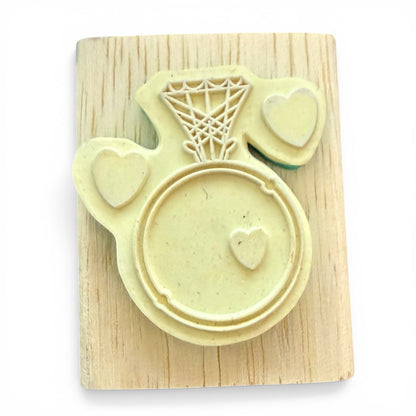 Stamp with ring with a heart on a wooden board