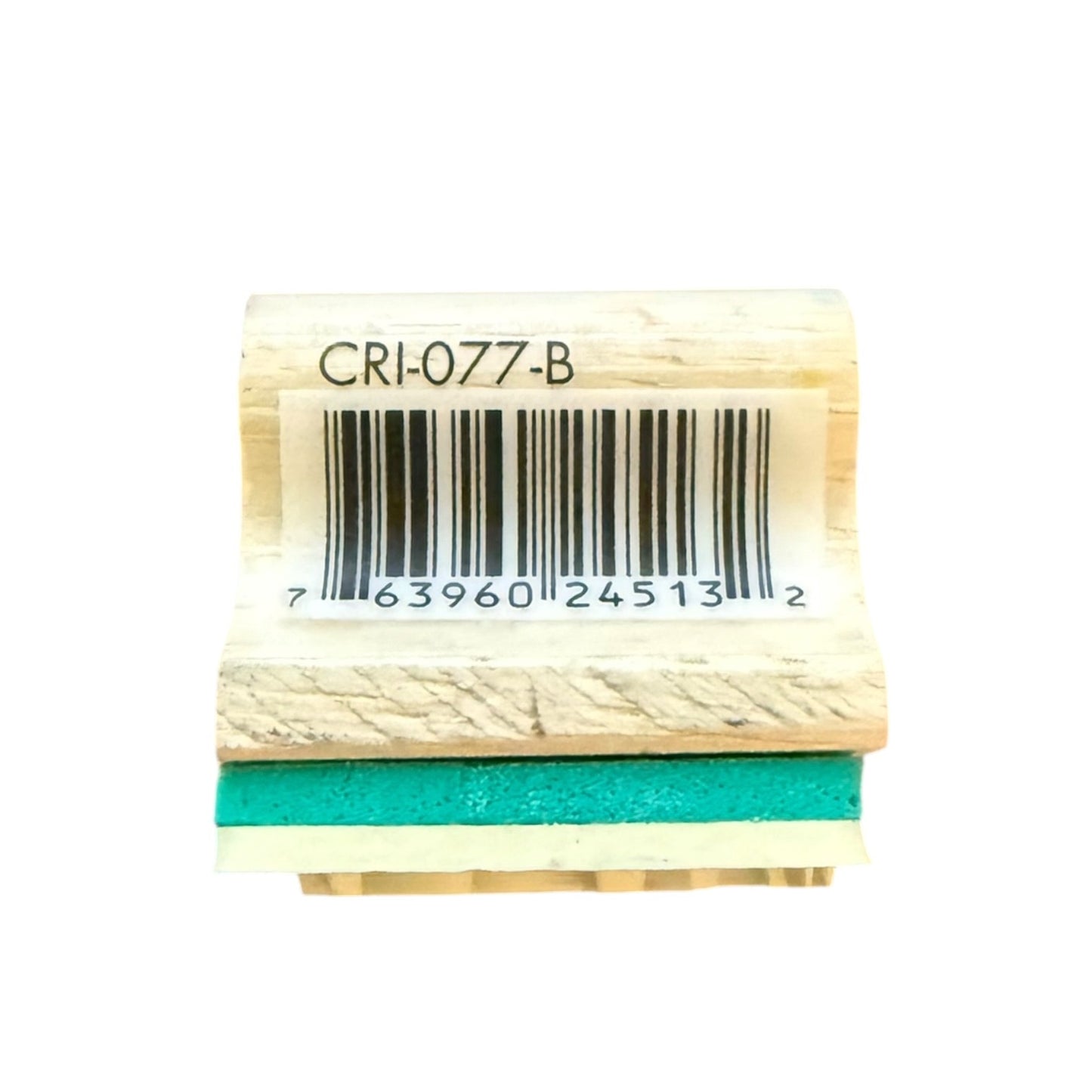 A small wooden stamp block with a barcode label reading CRI-077-B, featuring a teal rubber stamp face on a white background.