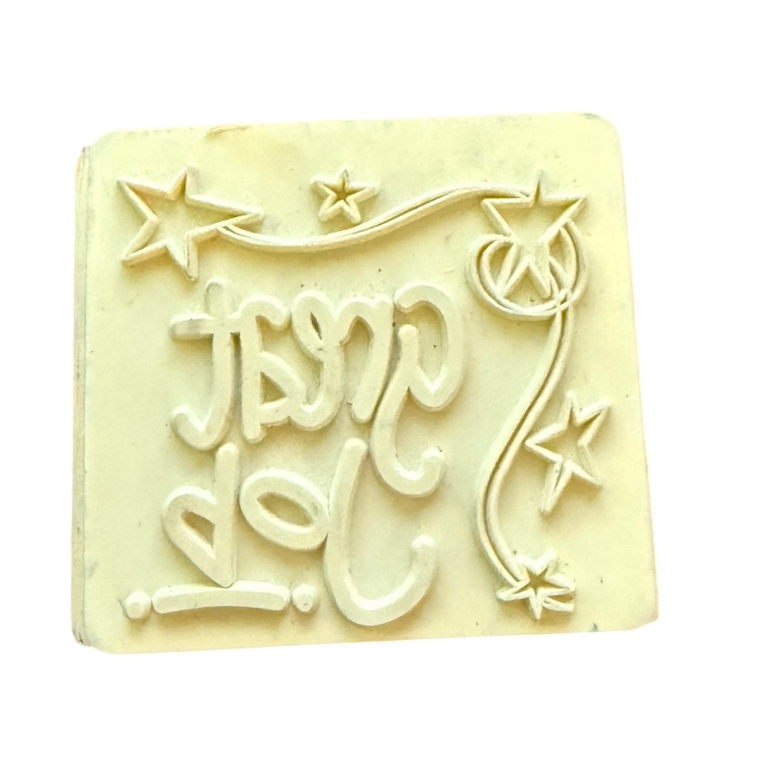 Square rubber stamp with text and star designs on a white background
