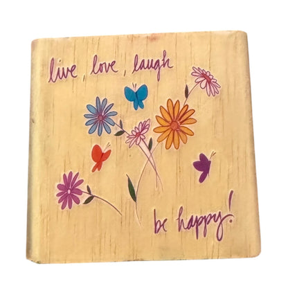 Wooden stamp with colorful flowers and butterflies and motivational text on a white background