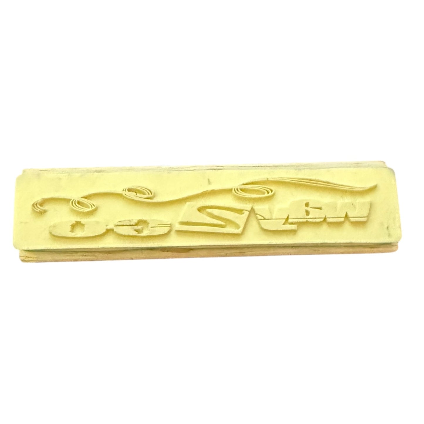 A rectangular rubber stamp , shown on a plain white background.
