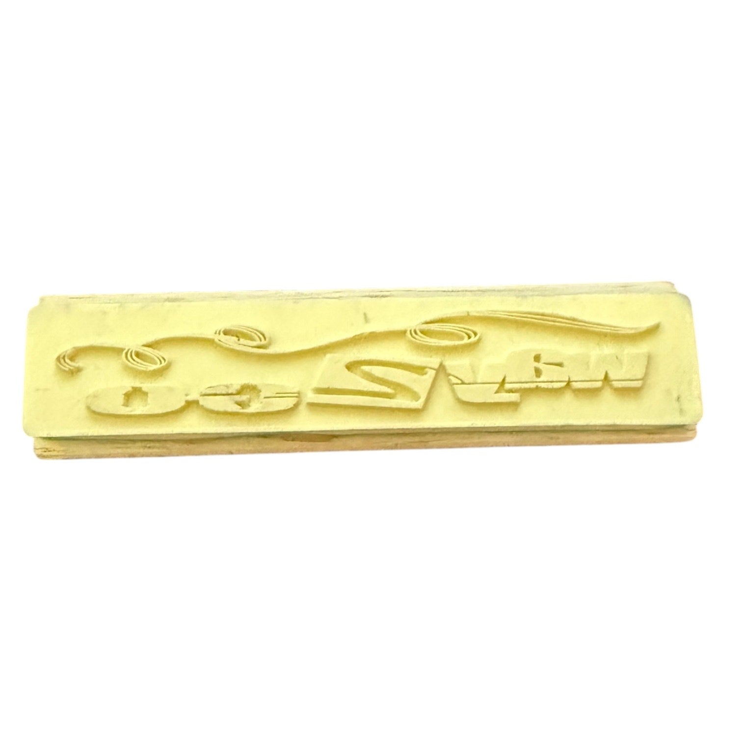 A rectangular rubber stamp , shown on a plain white background.