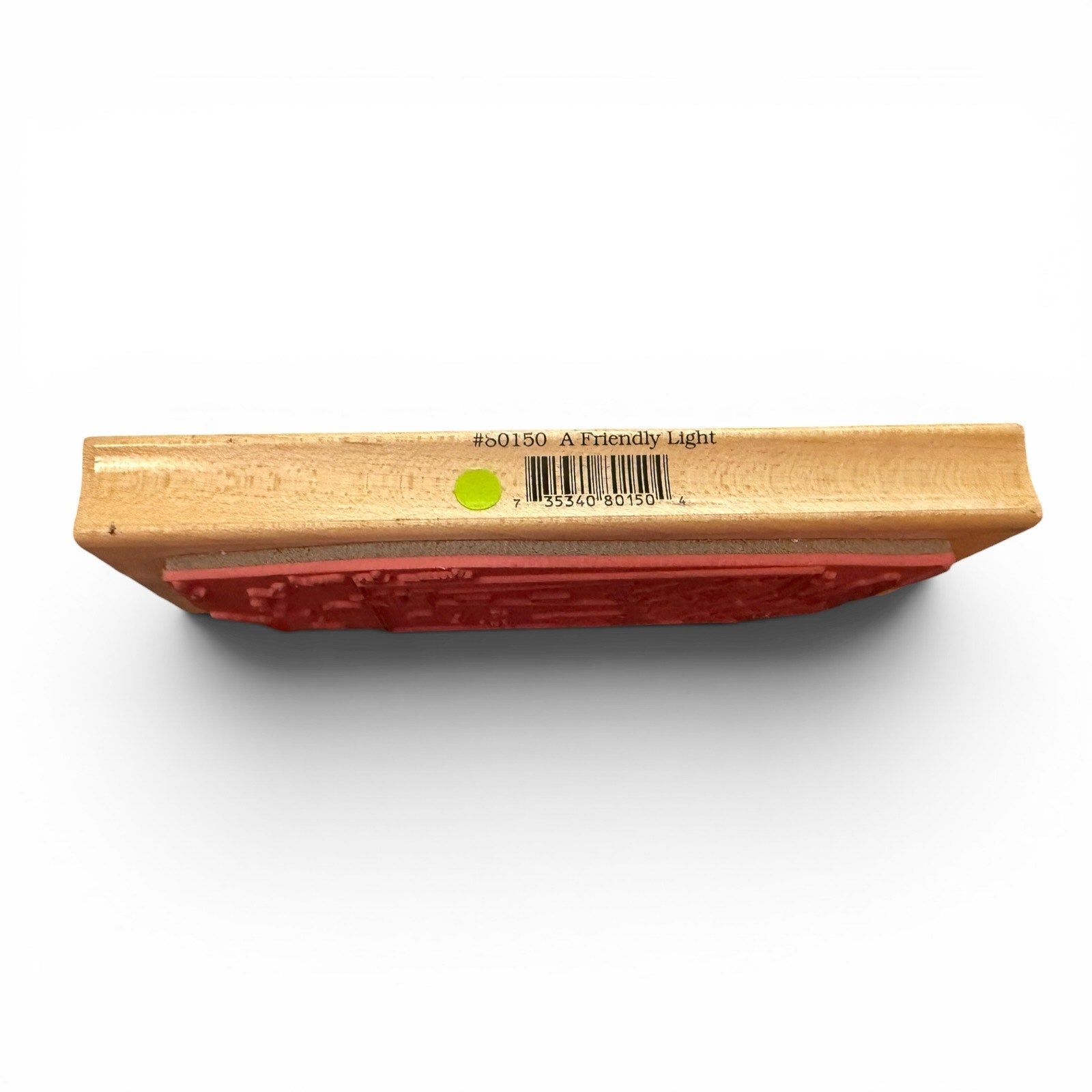 Wooden block with red rubber stamp on a white background