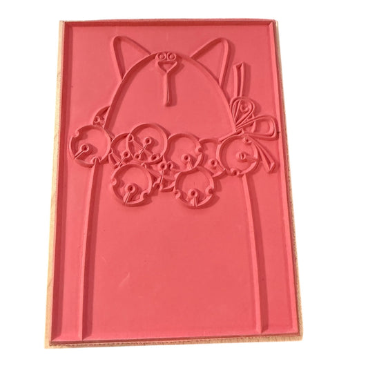 Red stamp with cat-shaped design on a white background