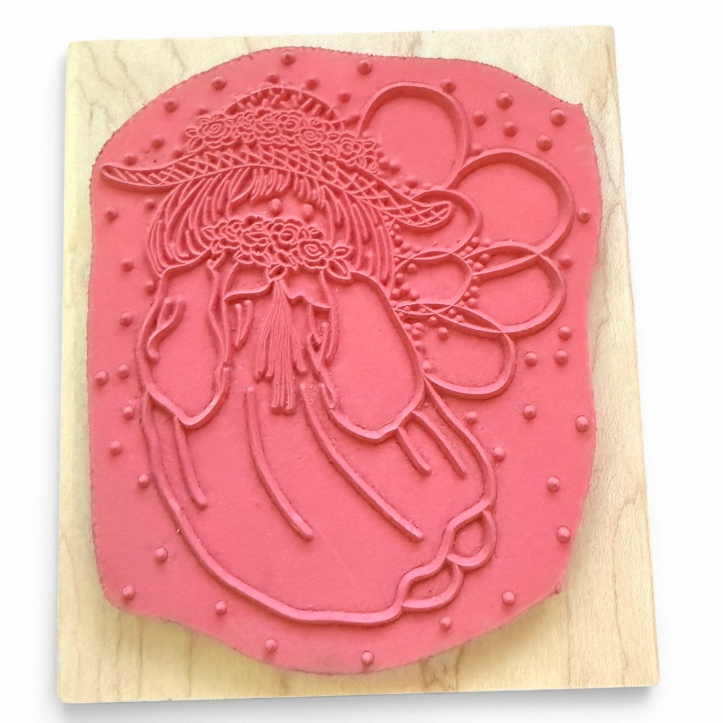 Girl in hat stamp on a wooden block