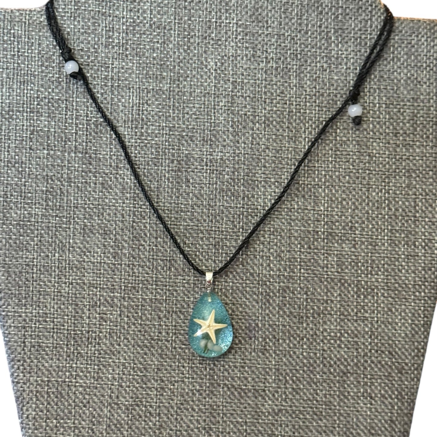 Necklace with a starfish pendant on a gray textured background