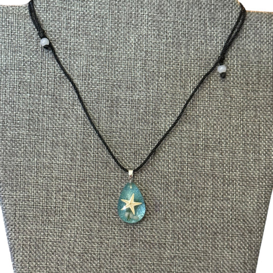 Necklace with a starfish pendant on a gray textured background