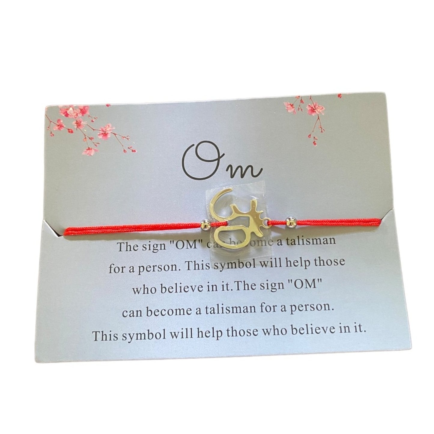 Bracelet with 'OM' symbol on a card with text about its significance