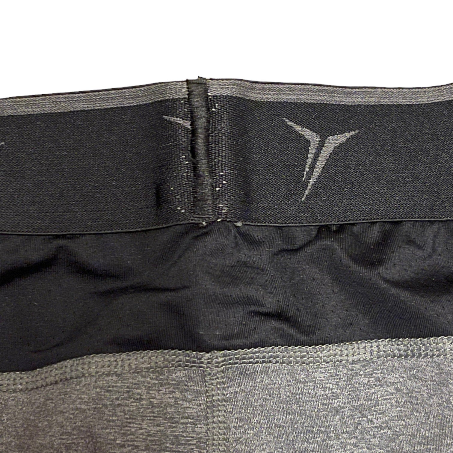 Close-up of a black and gray waist trainer with a brand logo on a white background