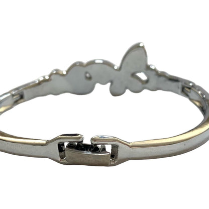 A silver-toned metal bangle bracelet featuring a butterfly-shape from the back and a clasp closure, shown against a plain white background.