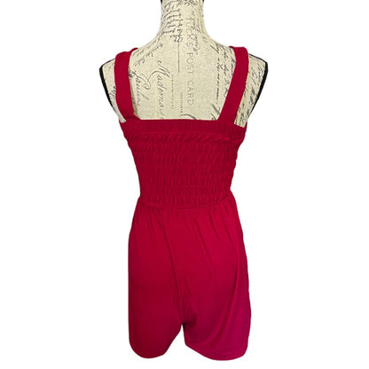 Back of red romper on a mannequin with a white background