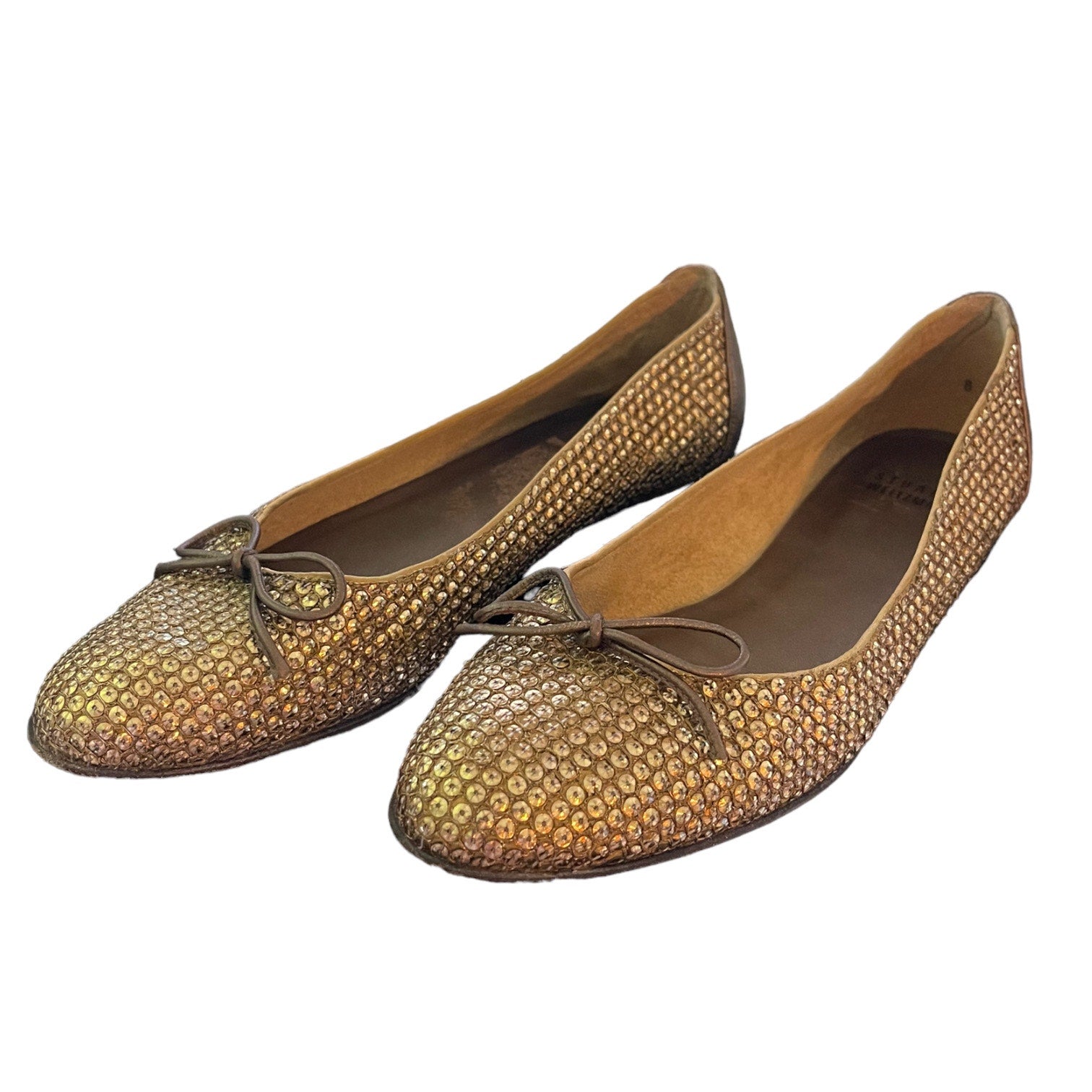 Front side of gold sequined ballet flats on a white background