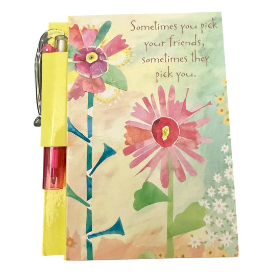Floral notebook with pen and quote on a white background