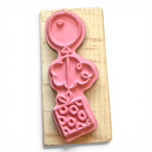 Pink rubber stamp on a wooden board