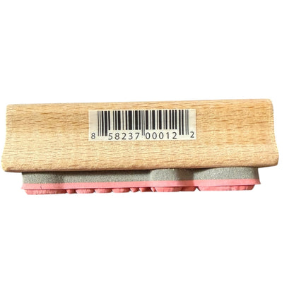 Side of rubber stamp with a barcode label on a white background