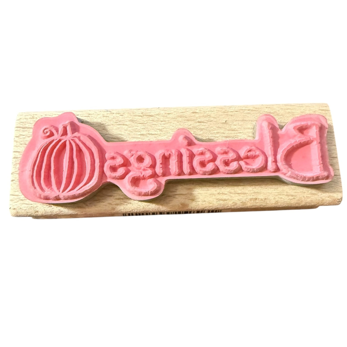 Rubber stamp on a wooden board with a white background