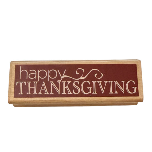 Rectangular wooden stmap with 'happy Thanksgiving' text on a white background