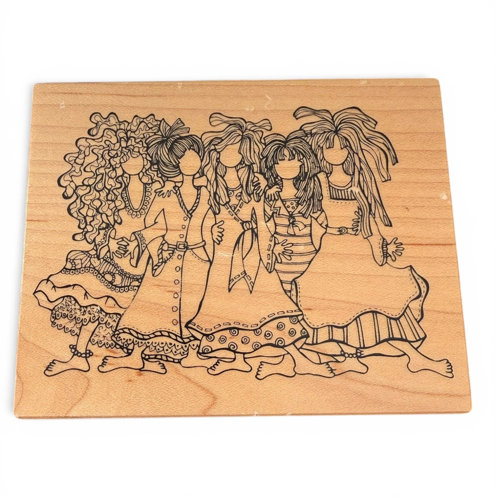 Wooden block with engraved illustration of five women in dresses on a white background