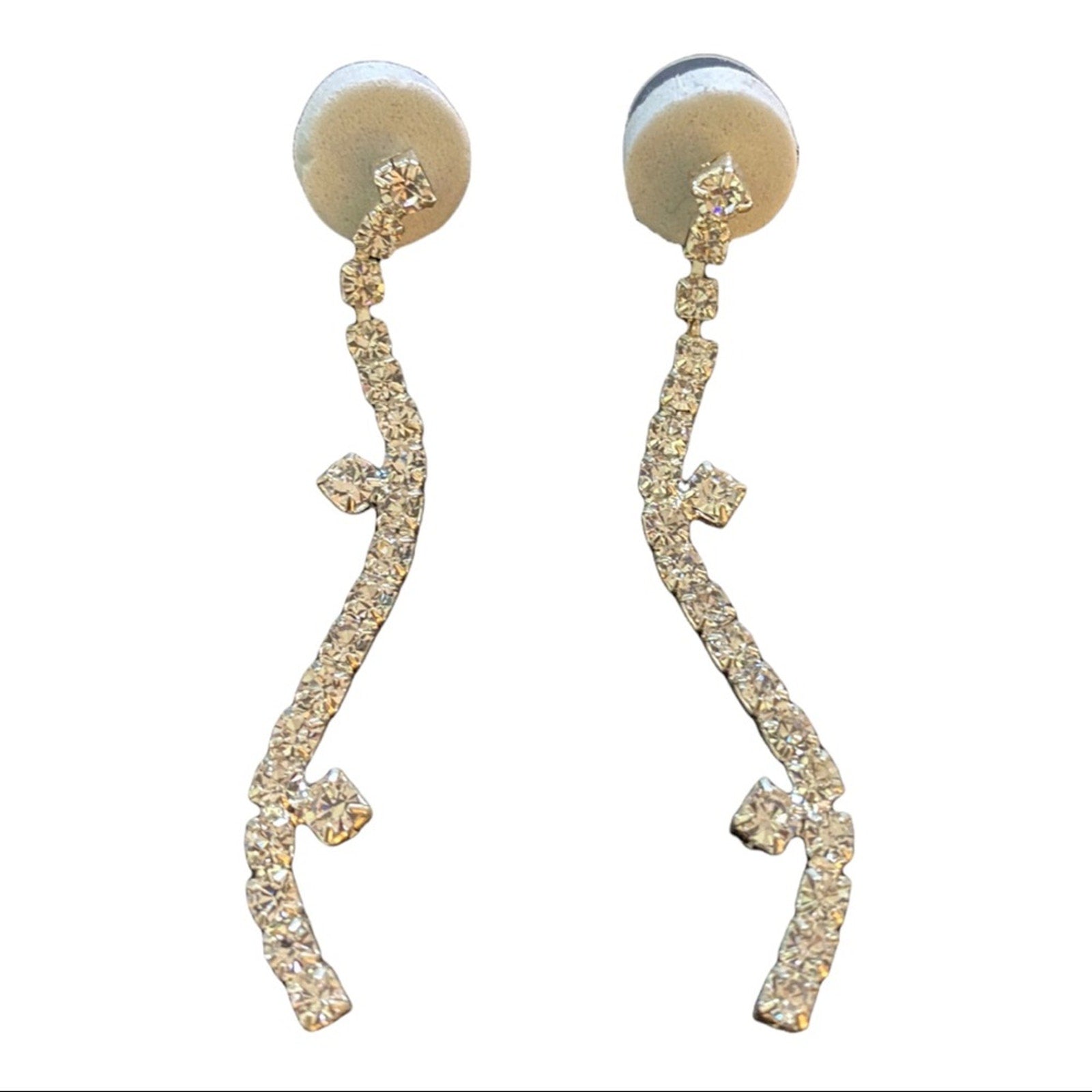 Pair of silver dangle earrings with intricate designs on a white background