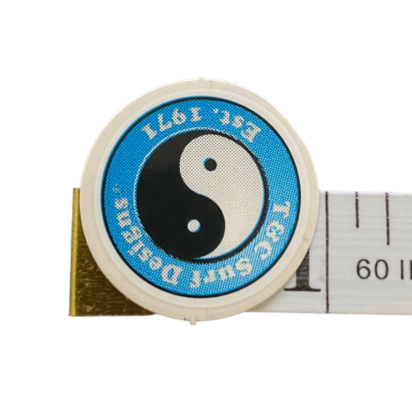 Tape measure with a blue and white circular sticker logo featuring a yin yang symbol on a white background.