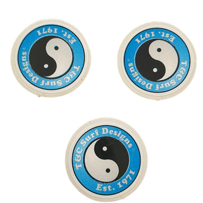 Three circular stickers with a yin yang symbol and text on a white background