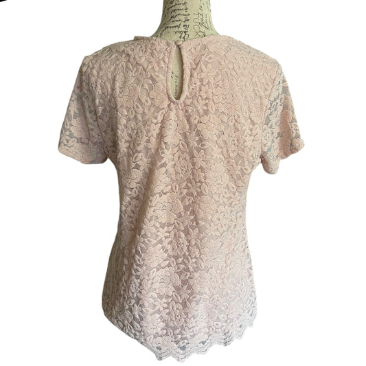 Back of pink  lace top on a mannequin against a white background