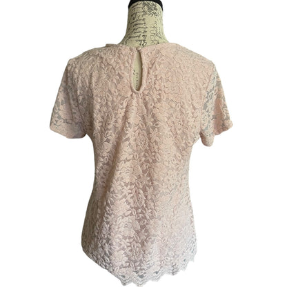 Back of pink lace top on a mannequin against a white background