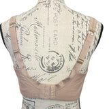 Back of bra on a mannequin with vintage-style background