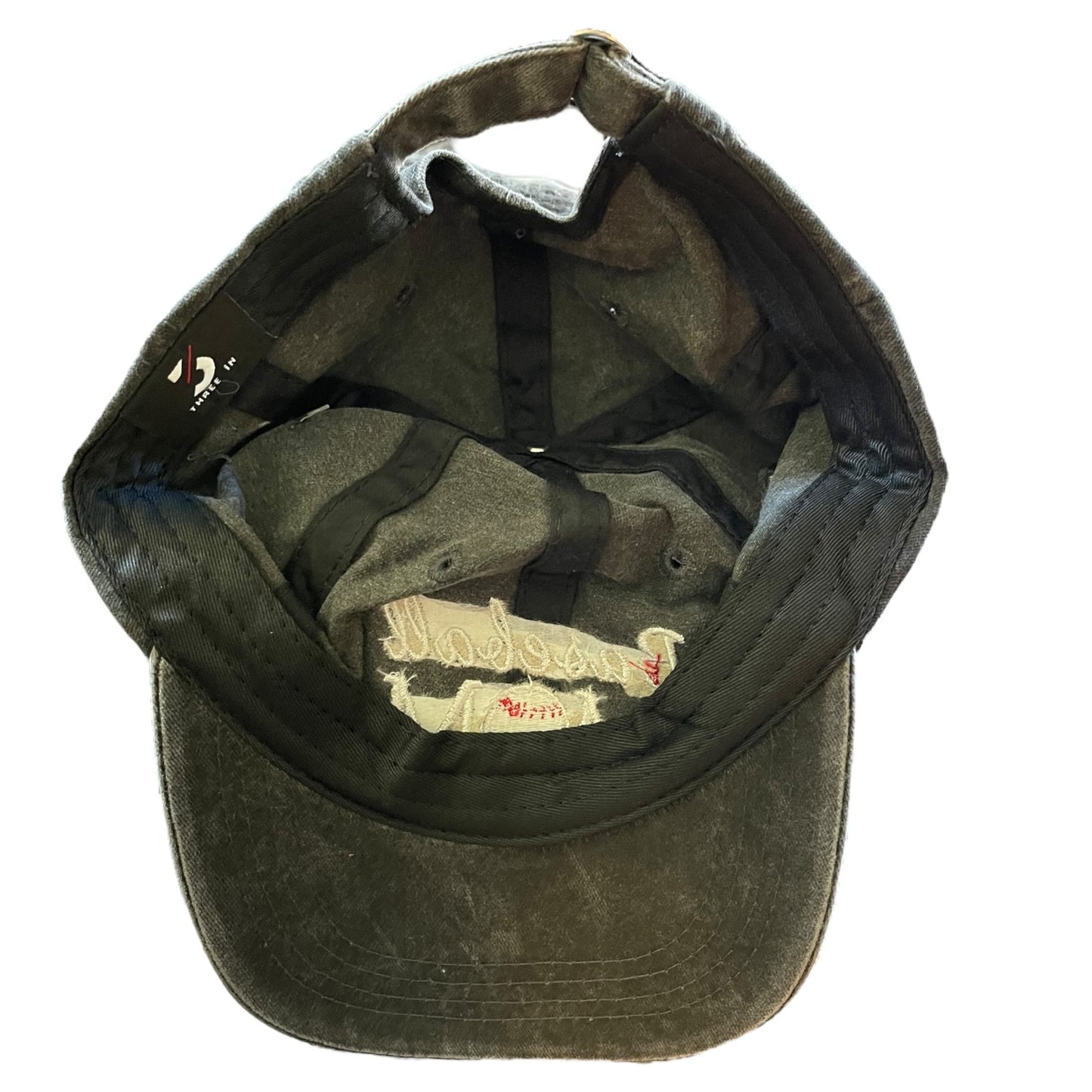 Bottom of cap with a logo on the inside against a white background