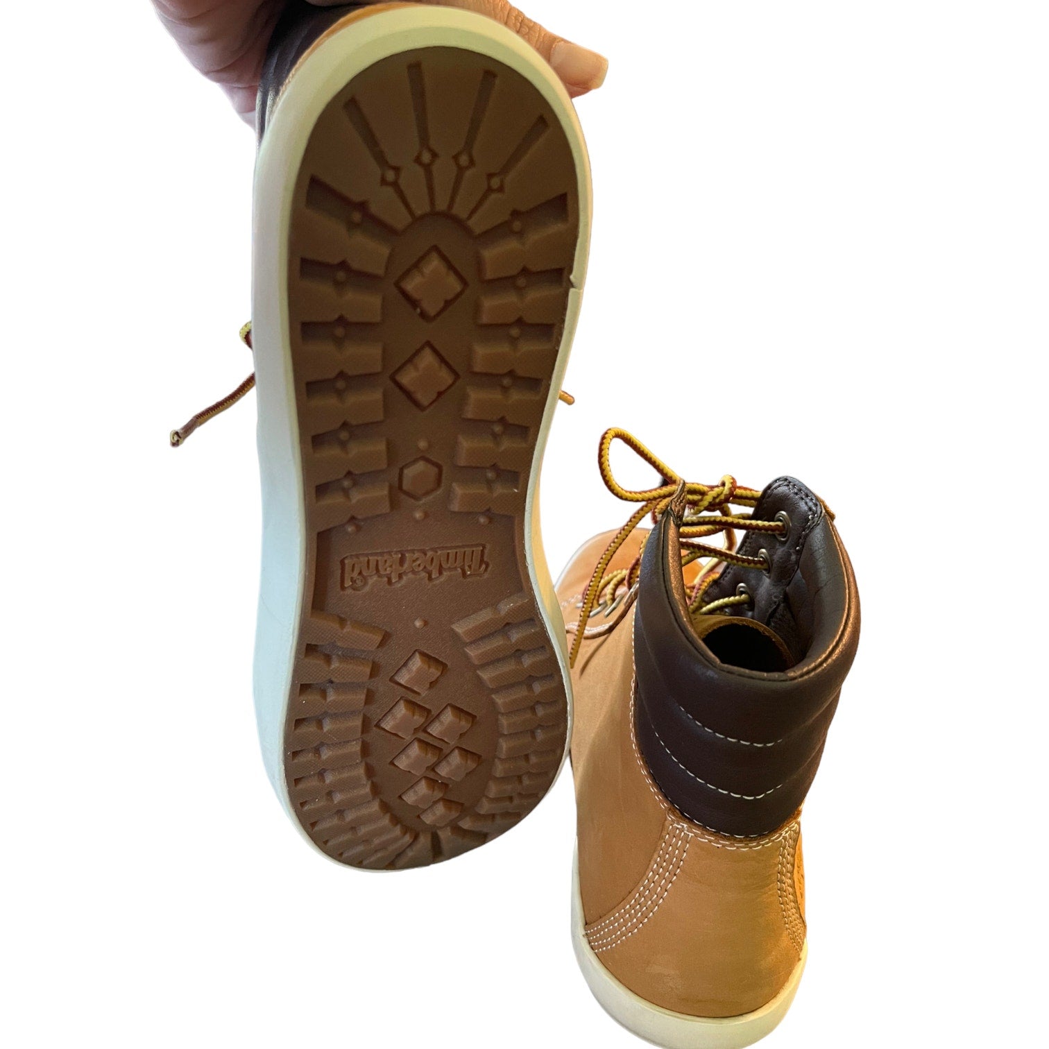 Tan boot with brown sole on a white background
