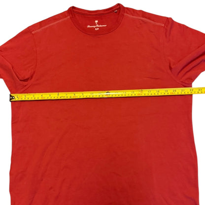 Red t-shirt with a measuring tape across it on a white background