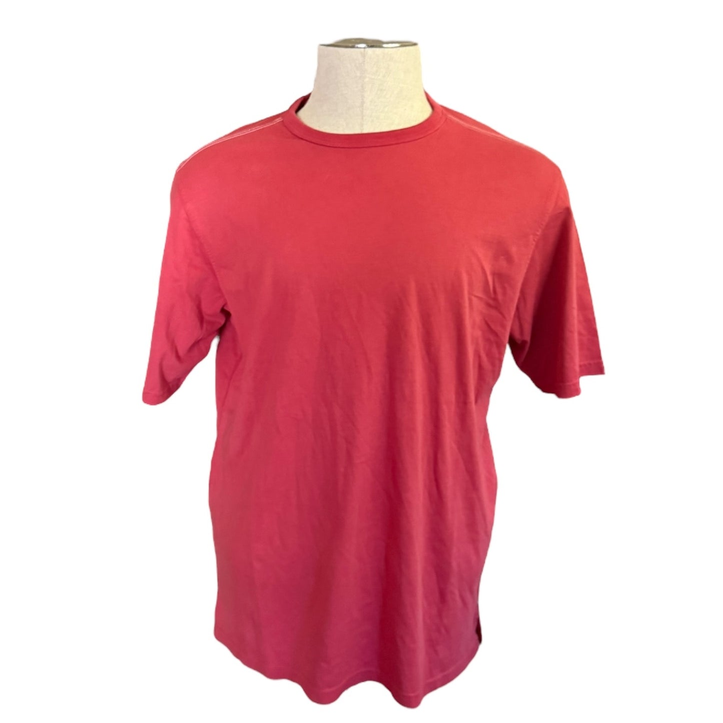 Red t-shirt on a mannequin against a white background