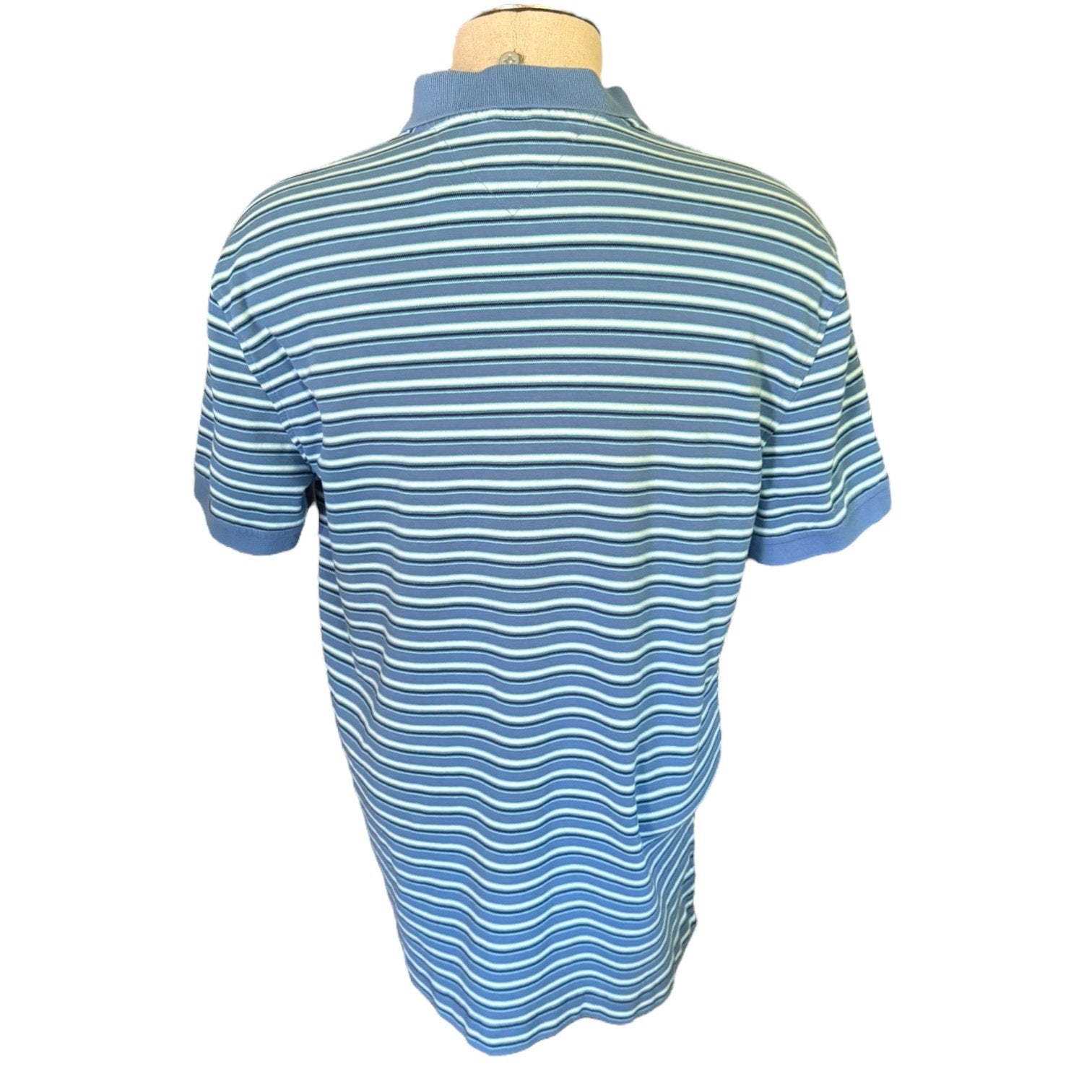 Back of Blue and white striped polo shirt on a mannequin against a white background