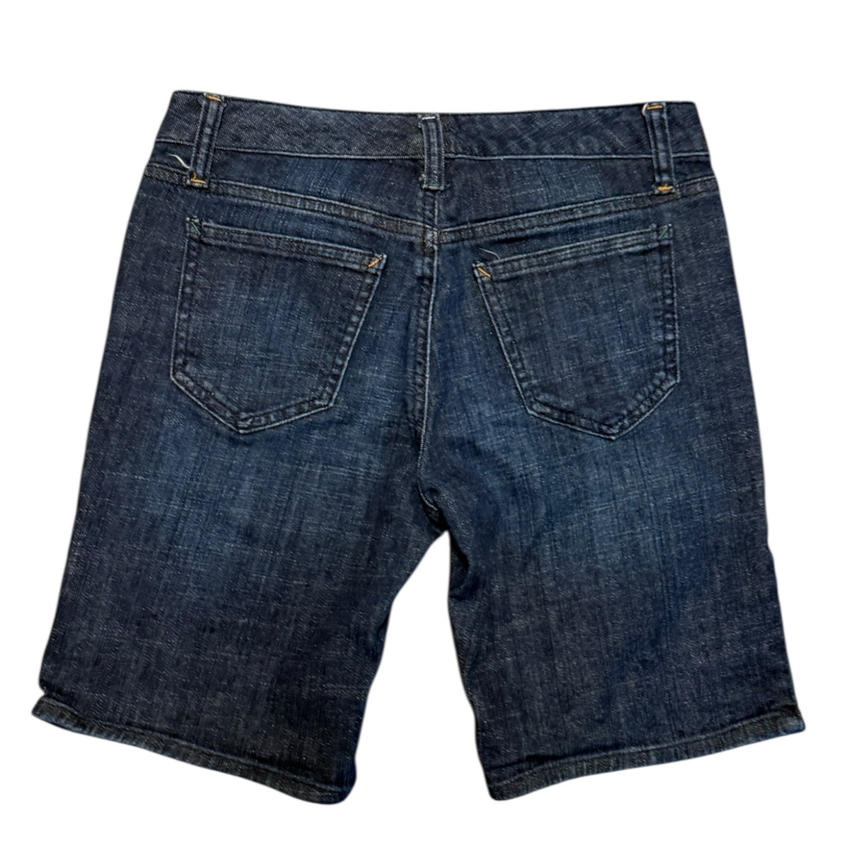 Back view of dark blue denim shorts showing the back pockets, waistband, and stitching details on a white background.