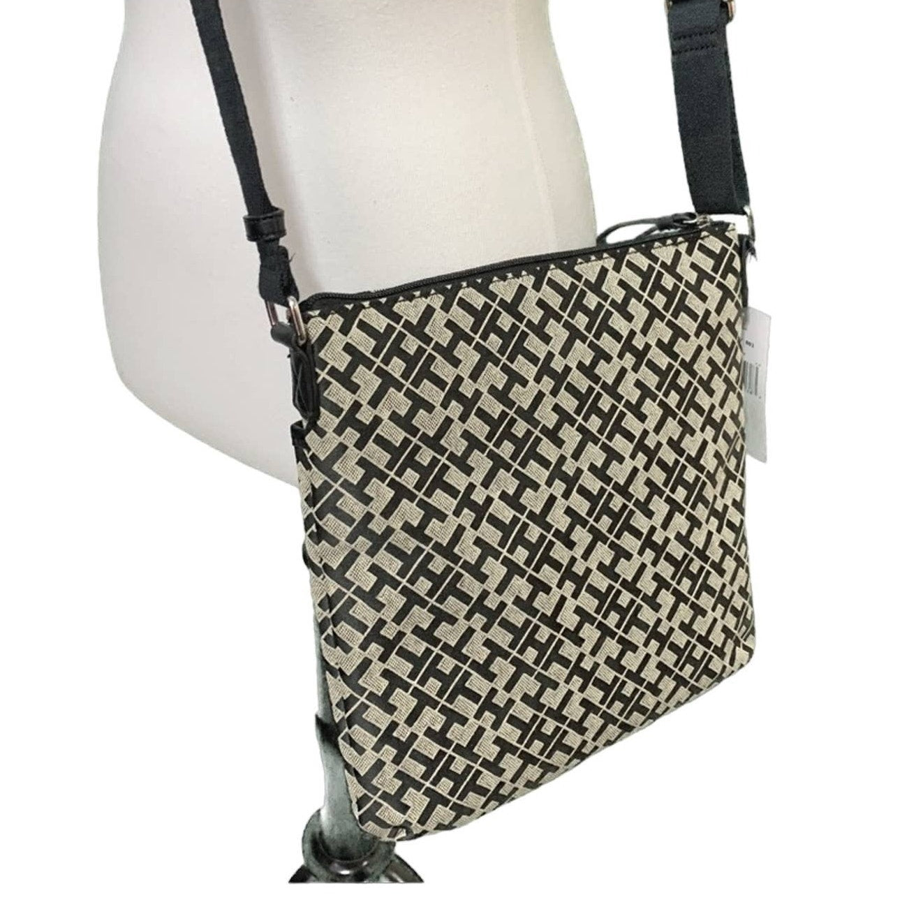 Crossbody bag with TH pattern on a mannequin against a white background