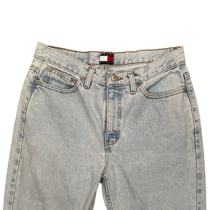 Light-wash blue denim jeans shown from the top on a plain white background, featuring a visible Tommy Hilfiger brand label at the center waistband.