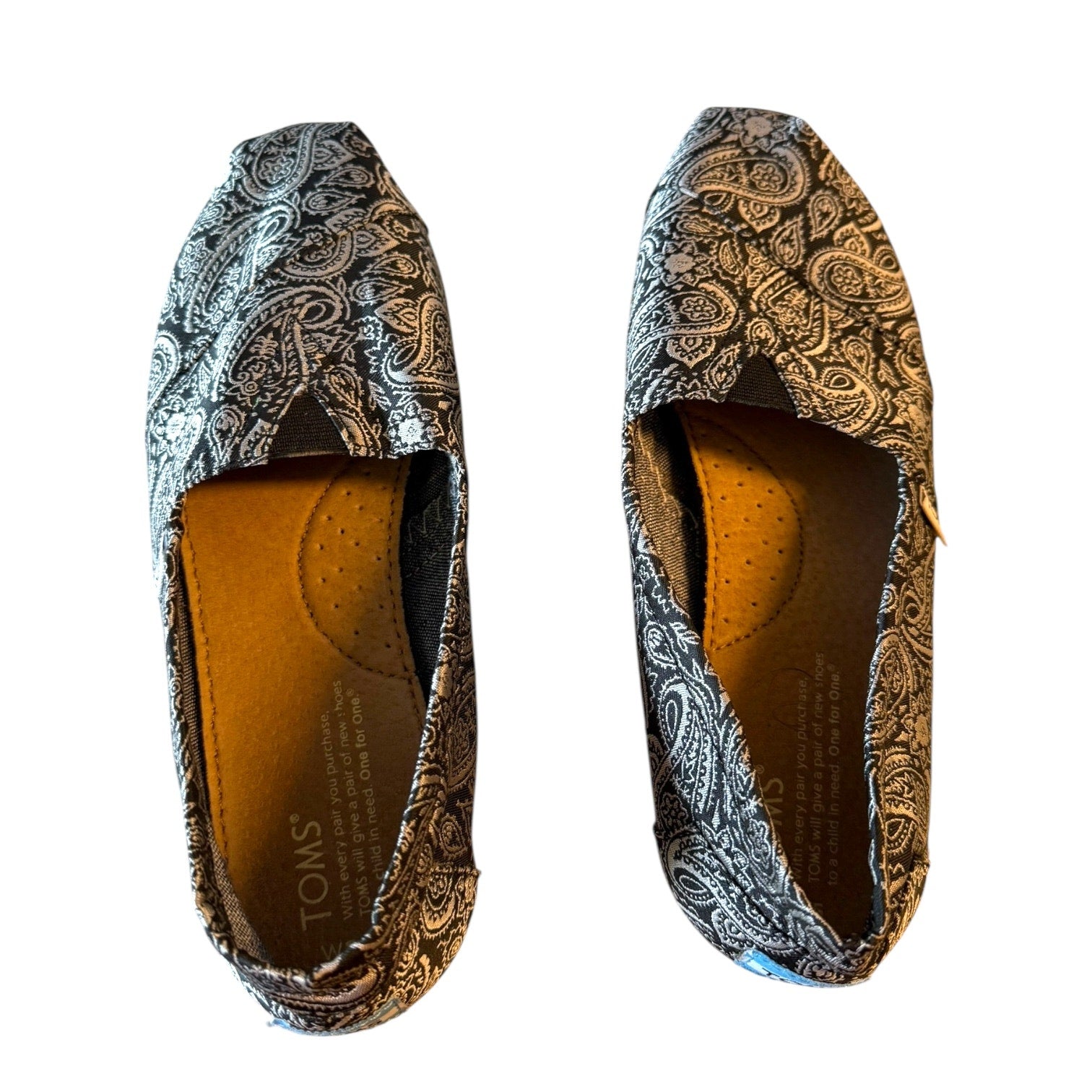 Top view of black and silver loafers on a white background