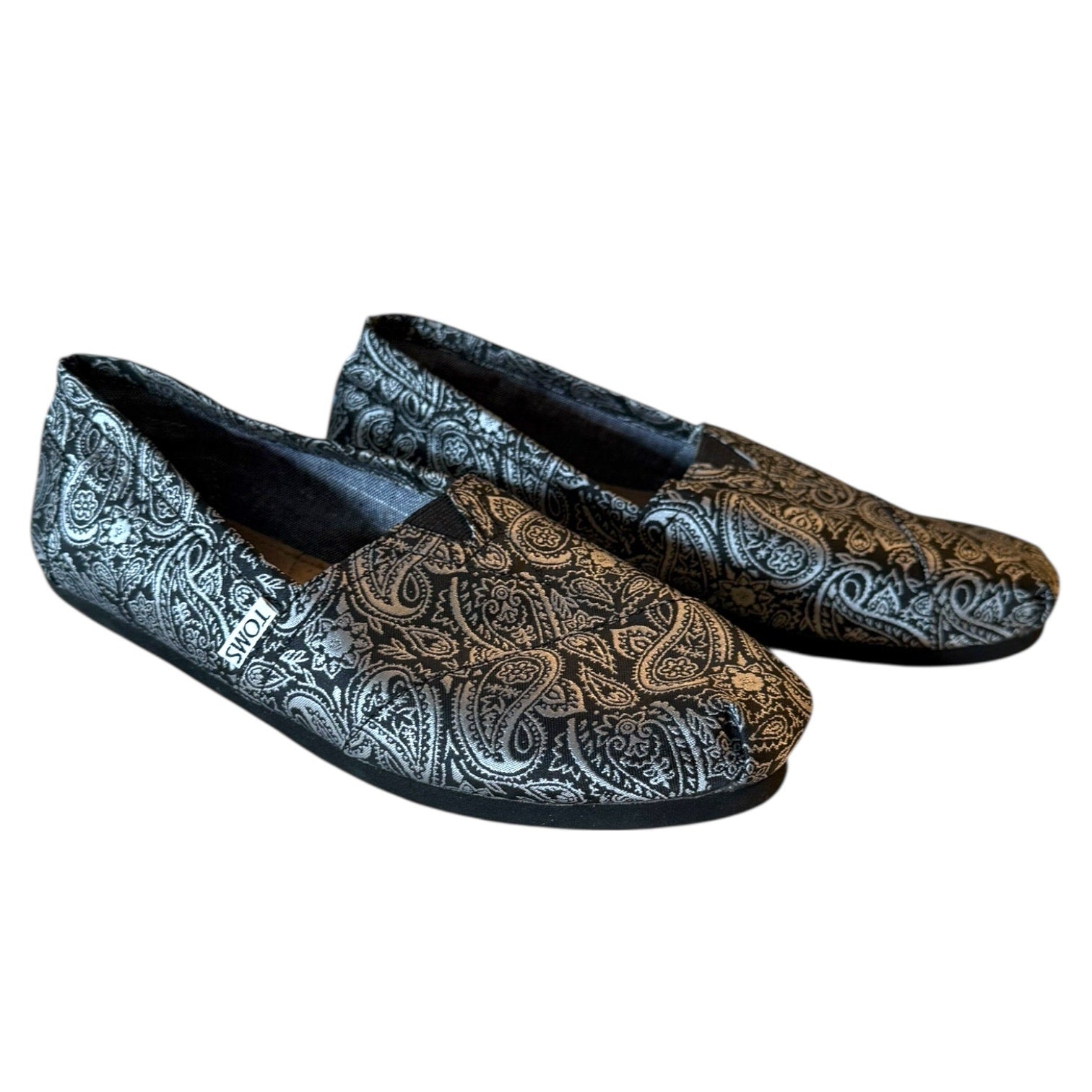 Pair of paisley patterned loafers on a white background