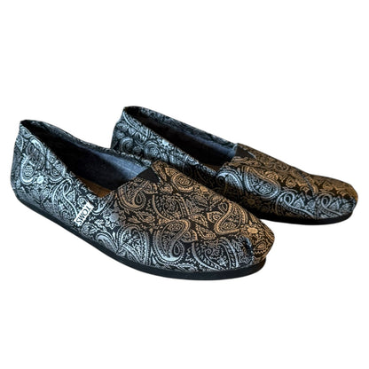 Pair of paisley patterned loafers on a white background