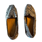 Top Pair of patterned flats on a white background