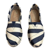 Pair of navy and white striped shoes on a white background