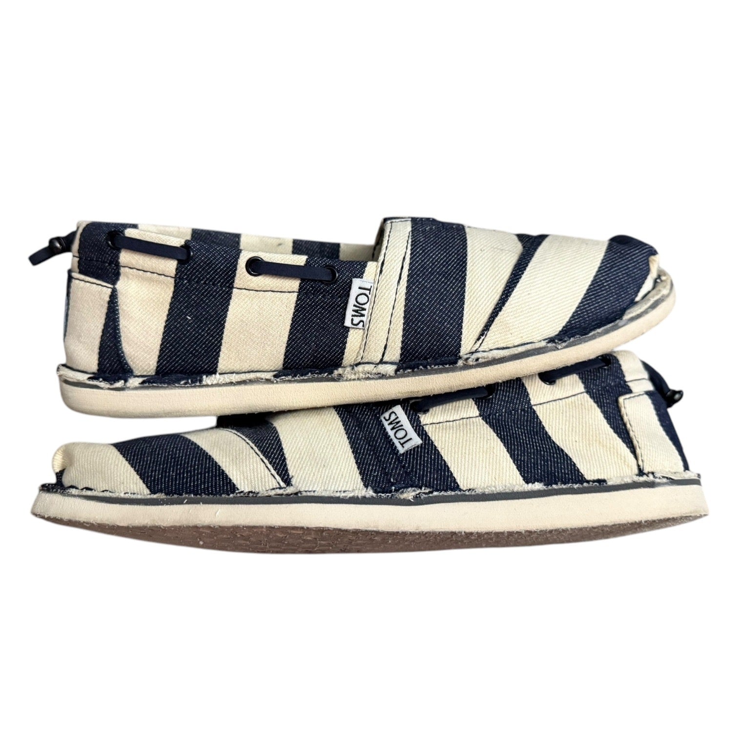 Pair of navy and white striped shoes on a white background