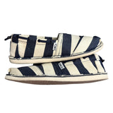 Pair of navy and white striped shoes on a white background