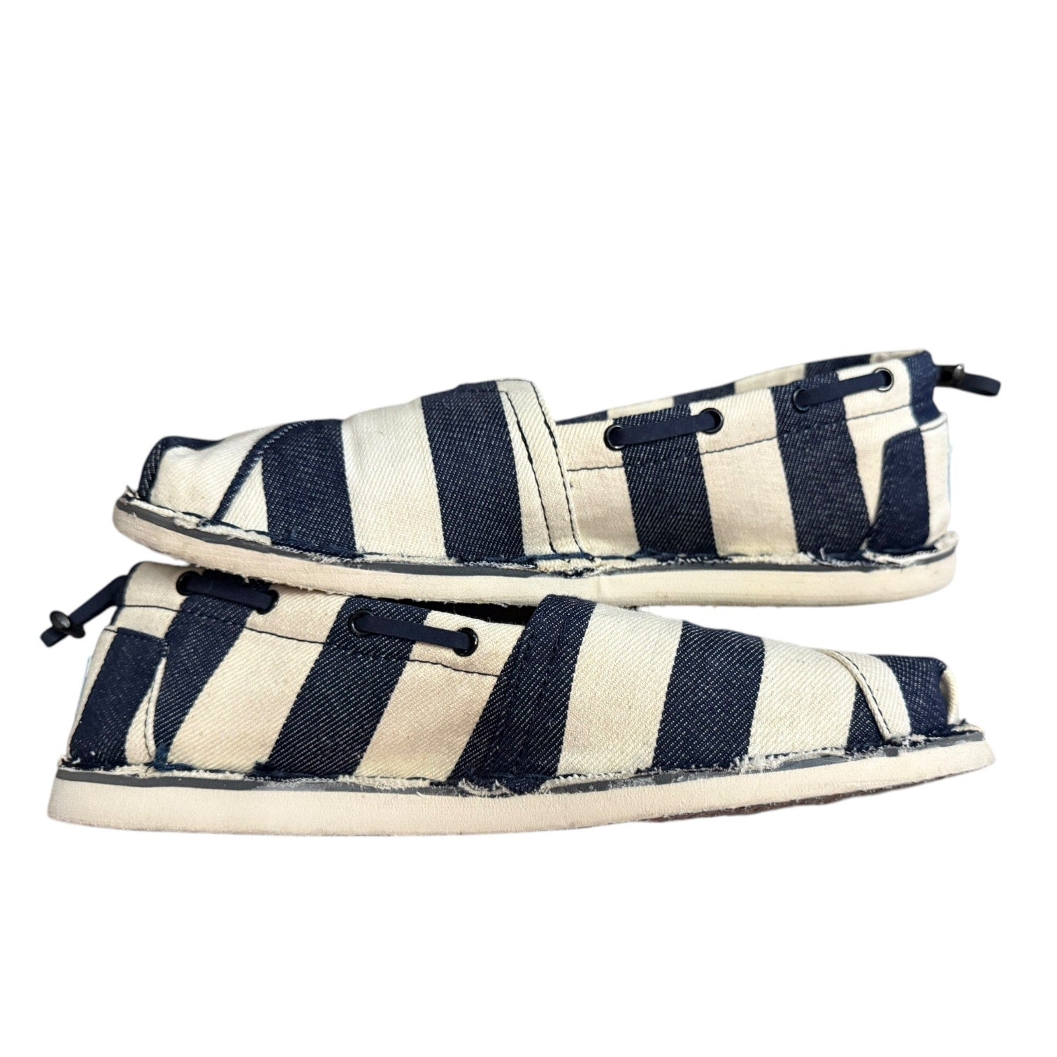 Pair of navy and white striped shoes on a white background