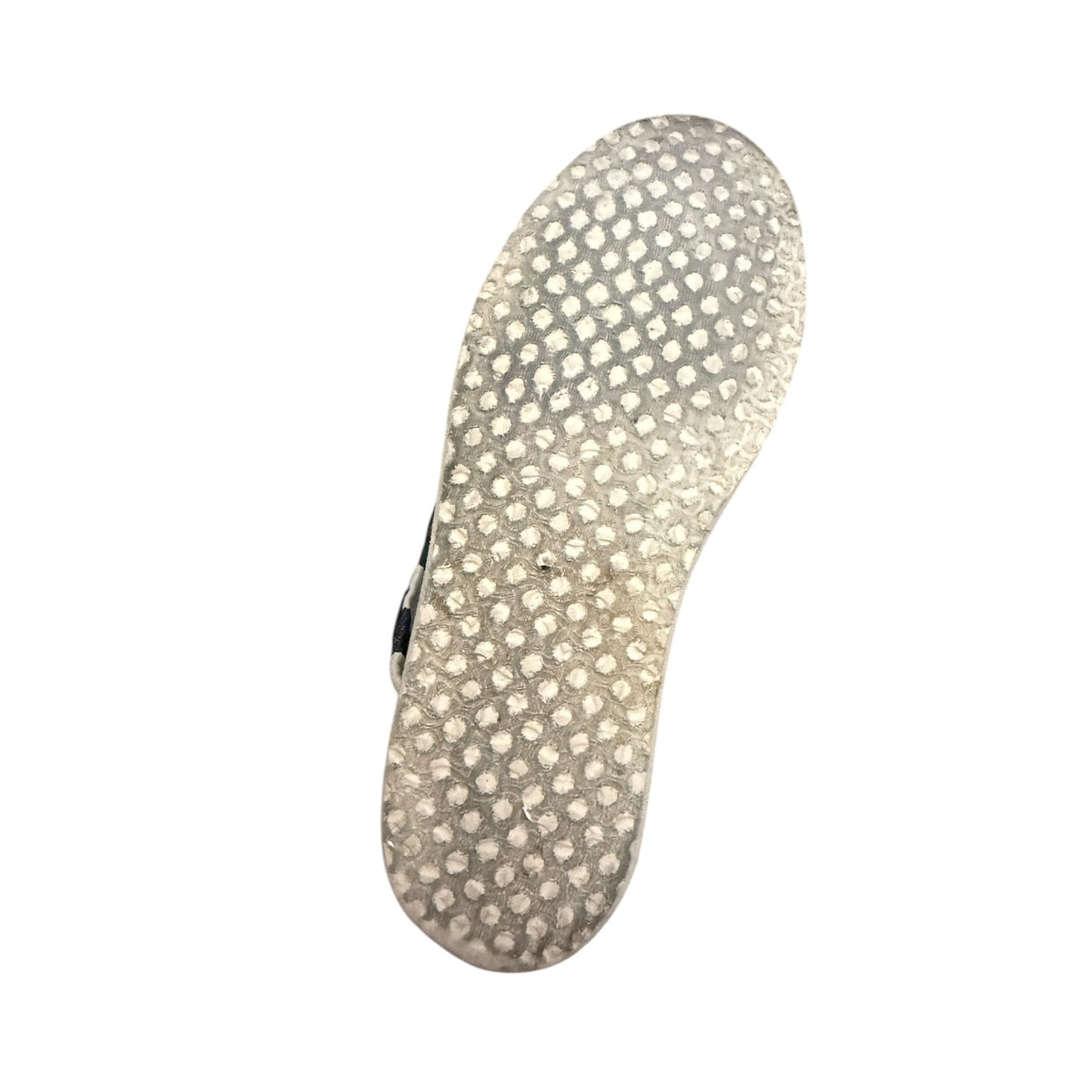 A bottom of TOMS shoes set against a plain white background.
